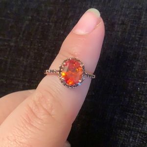 Rose gold metal band with orange stone